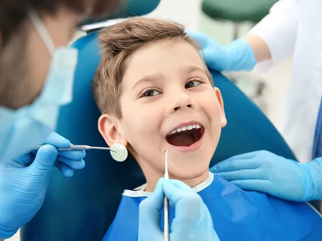 A young boy receiving a dental checkup and cleaning