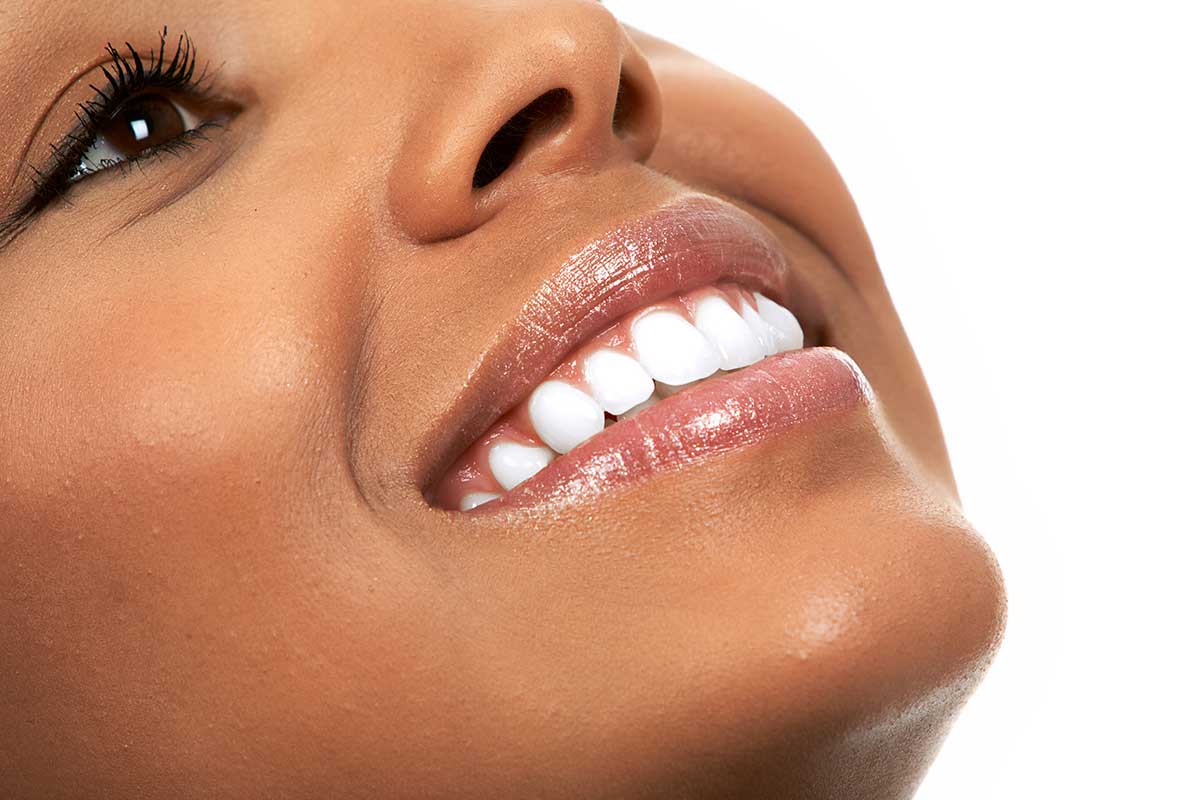 Portrait shot of bright white smile on black female model